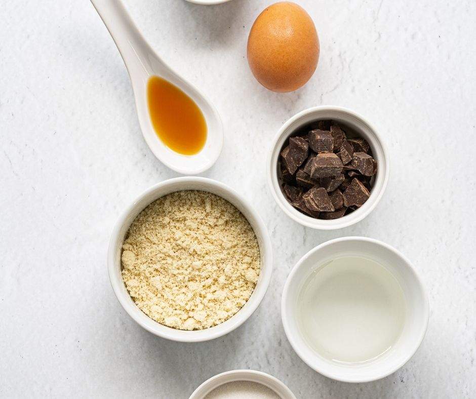Almond flour mug cake ingredients (almond flour, coconut oil, vanilla, chocolate chunks, an egg)