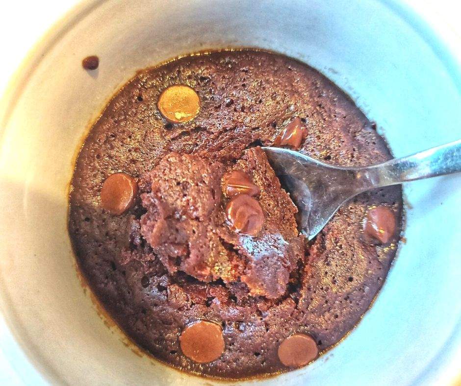 Brownie in a mug with a spoonful