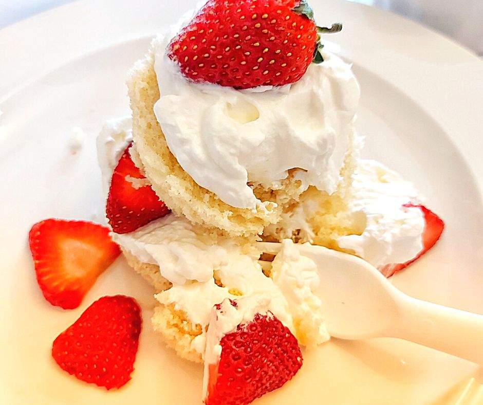 Strawberry shortcake with a bite on a fork
