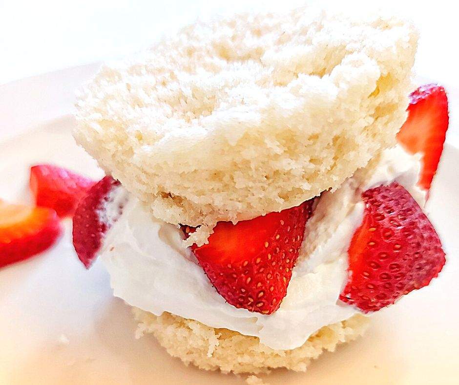Strawberry shortcake filled with whipped cream and sliced strawberries
