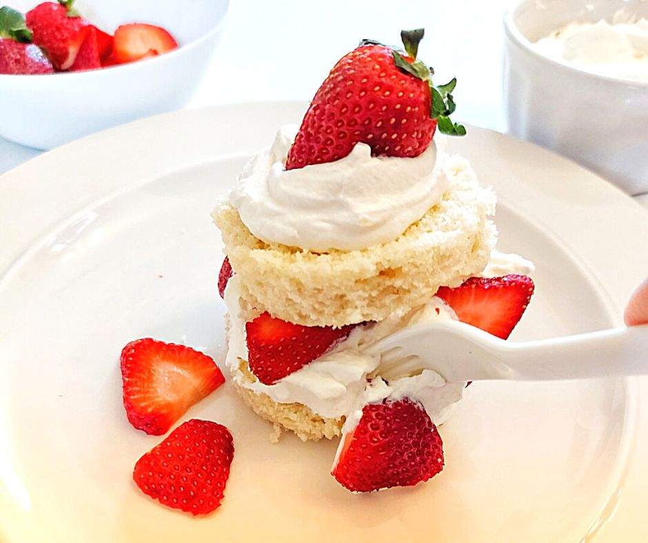 Strawberry shortcake with a bite on a fork