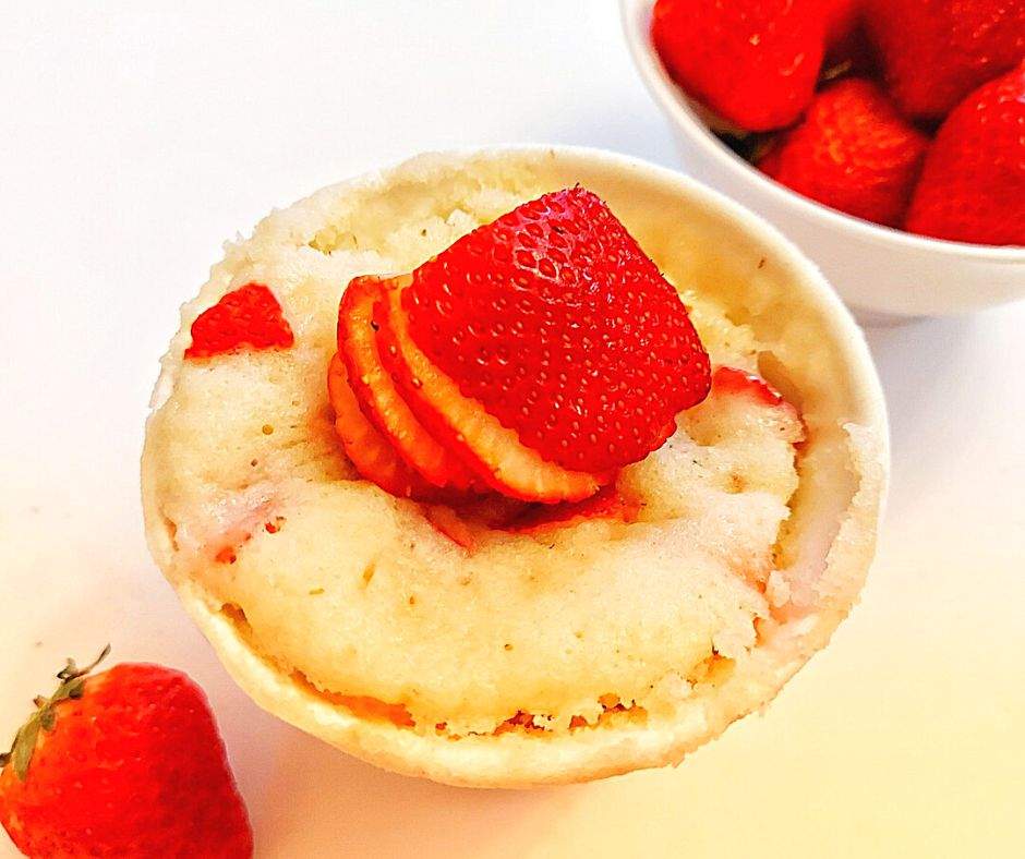 Strawberry mug cake topped with whipped cream