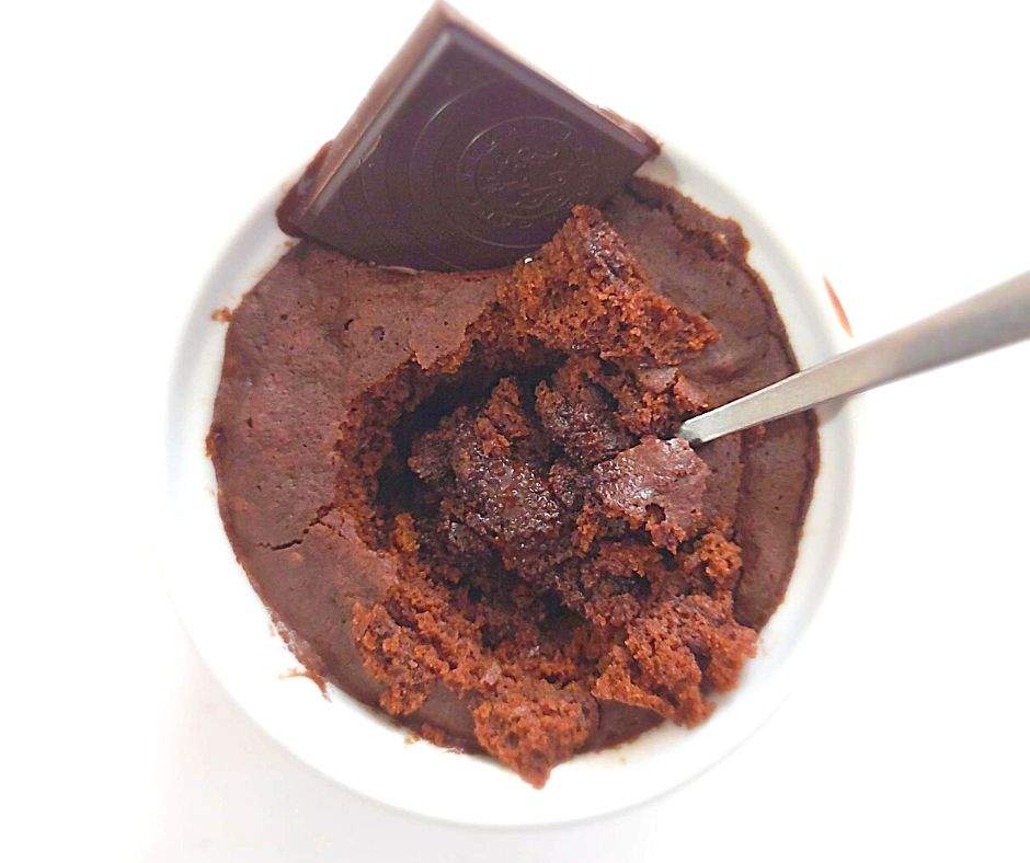 Gooey chocolate mug cake with a chocolate square